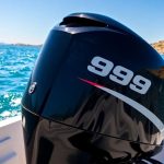 9.9 HP outboard motor on a boat in water.