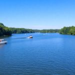 Serene lake with boats and green trees in Illinois.