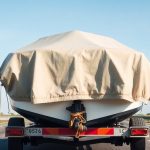 Boat on trailer with cover.