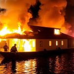Emergency services at night boat fire.