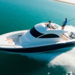Sleek fishing boat on calm blue water.