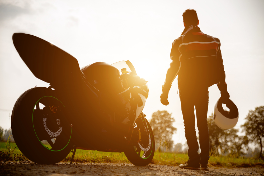 Motorcycle with rider walking toward it