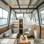 a-photo-of-a-small-yacht-interior-with-a_r3Bs5XkOTSaXBvXWATqMTg_7ZboDuwhQHevagy9fnO-ZQ