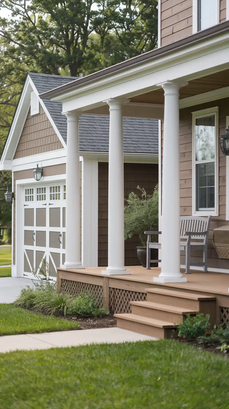 A front porch with columns sits adjacent to a garage, creating a charming and inviting entryway for the house
