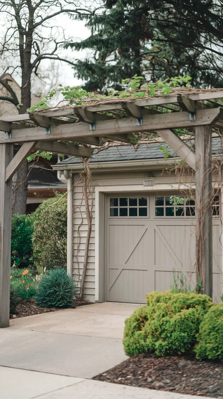 A house with a front garage featuring a stylish pergola or trellis over the entryway, adding a touch of elegance and curb appeal
