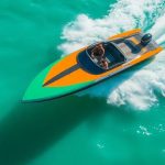 Scarab boat on water, fast, sleek.