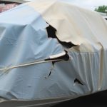 Tattered boat cover on old boat.