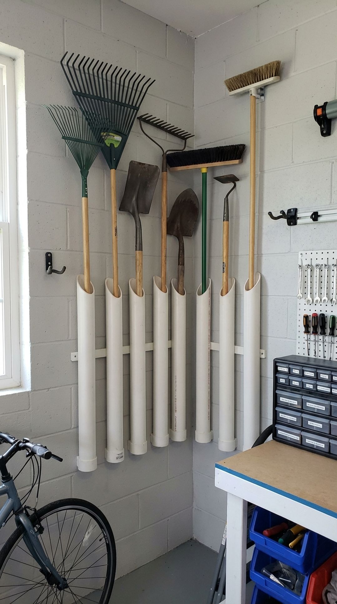 PVC pipe holders storing long-handled tools