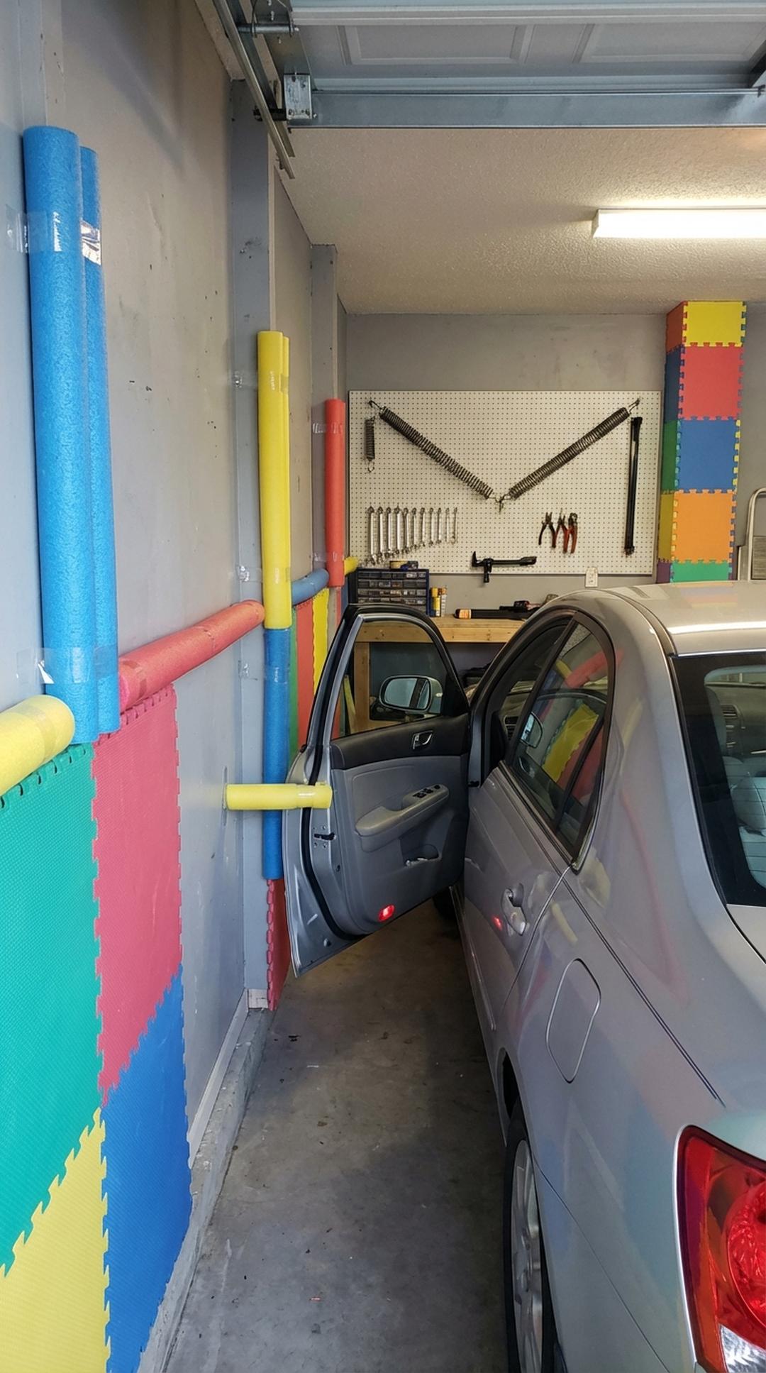 Pool noodles protecting garage walls